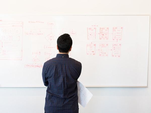 man-standing-infront-of-white-board-1181345